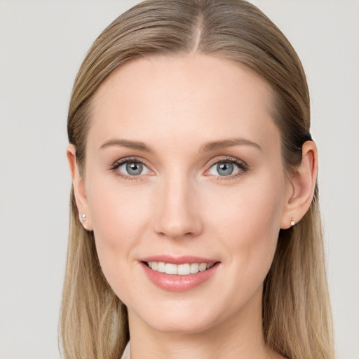 Joyful white young-adult female with long  brown hair and blue eyes