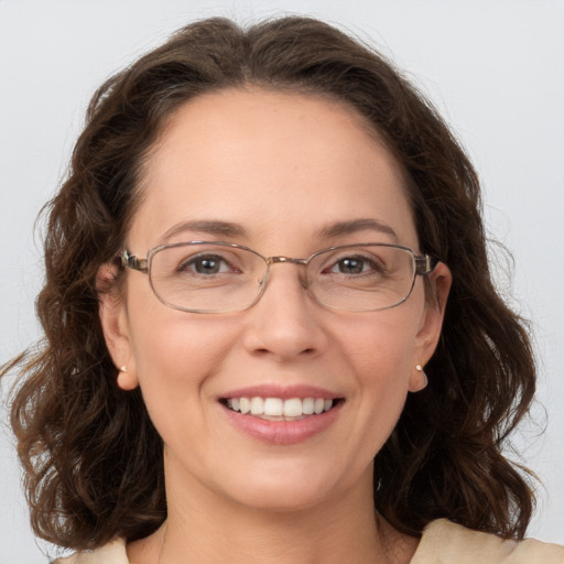 Joyful white adult female with medium  brown hair and grey eyes