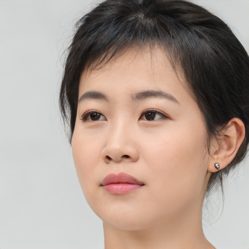Neutral asian young-adult female with medium  brown hair and brown eyes