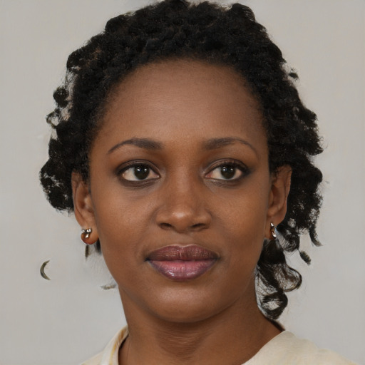 Joyful black young-adult female with medium  brown hair and brown eyes