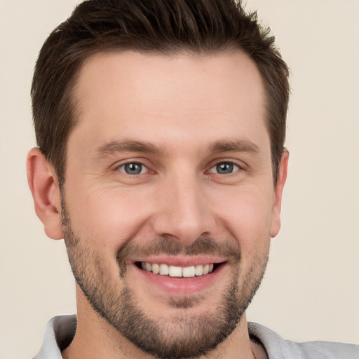 Joyful white young-adult male with short  brown hair and brown eyes