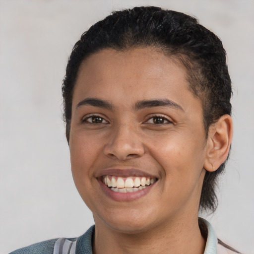 Joyful latino young-adult female with short  brown hair and brown eyes