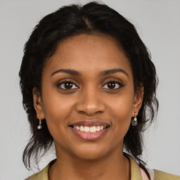 Joyful black young-adult female with medium  brown hair and brown eyes