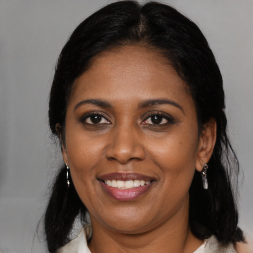 Joyful black adult female with medium  black hair and brown eyes
