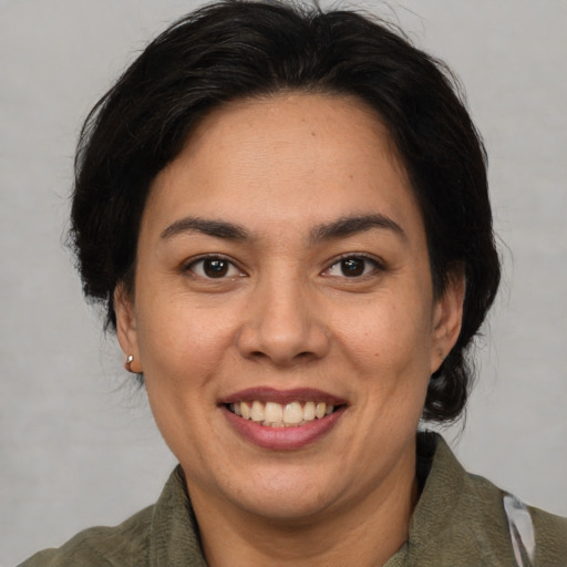 Joyful asian adult female with medium  brown hair and brown eyes