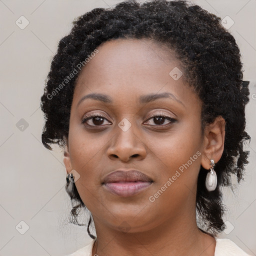 Joyful black young-adult female with long  brown hair and brown eyes