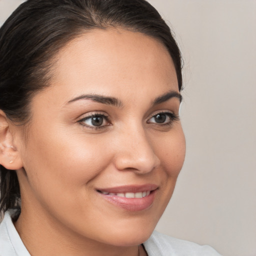 Joyful white young-adult female with medium  brown hair and brown eyes