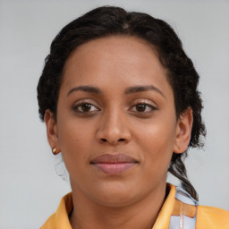 Joyful black young-adult female with medium  brown hair and brown eyes