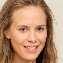 Joyful white young-adult female with long  brown hair and green eyes