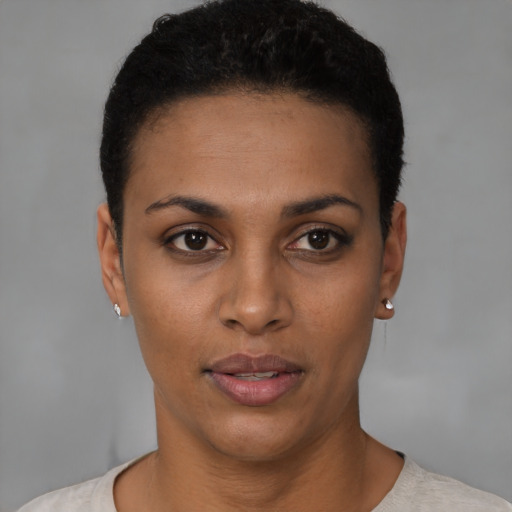 Joyful latino young-adult female with short  black hair and brown eyes
