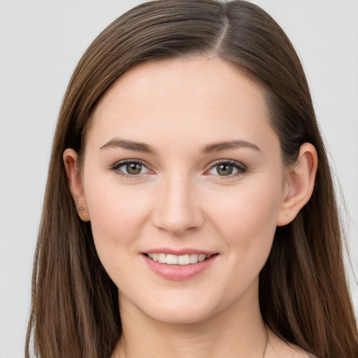 Joyful white young-adult female with long  brown hair and grey eyes