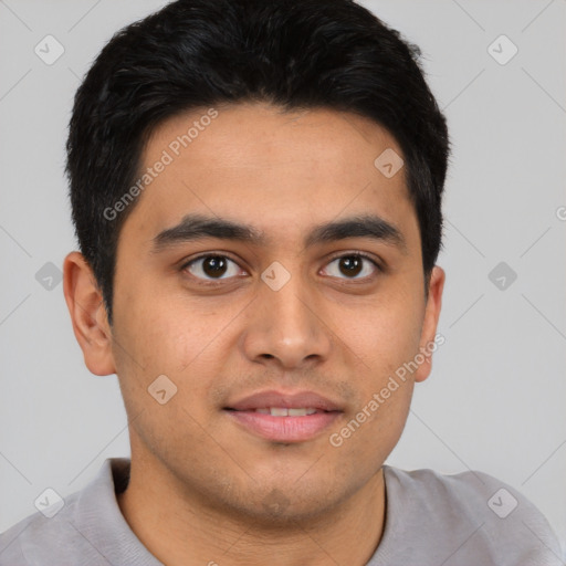 Joyful latino young-adult male with short  brown hair and brown eyes