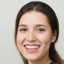 Joyful white young-adult female with long  brown hair and green eyes