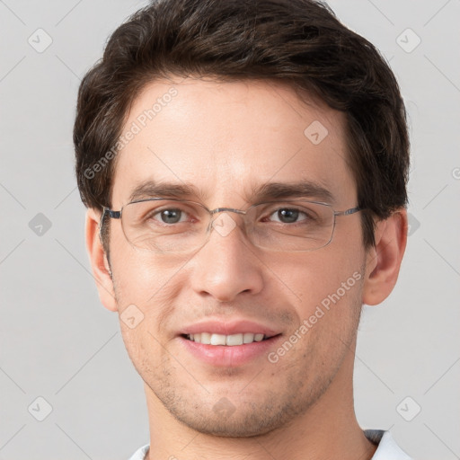 Joyful white young-adult male with short  brown hair and grey eyes