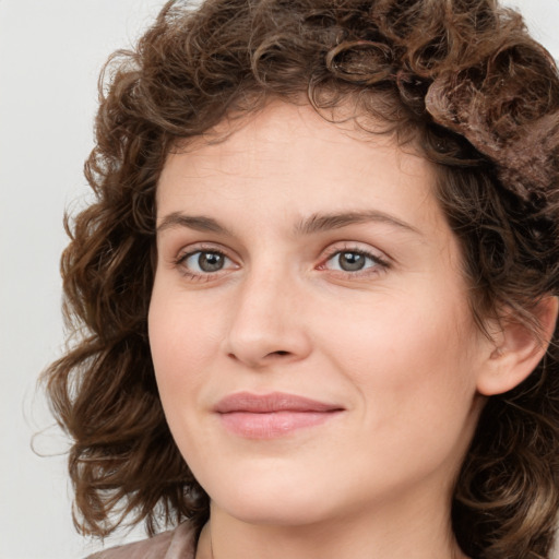 Joyful white young-adult female with medium  brown hair and green eyes