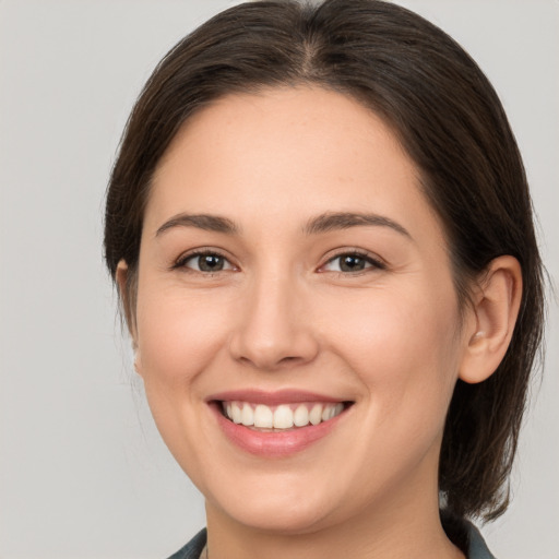 Joyful white young-adult female with medium  brown hair and brown eyes