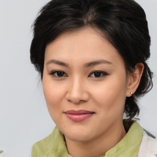Joyful asian young-adult female with medium  brown hair and brown eyes