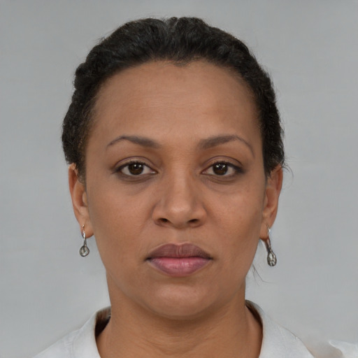 Joyful black adult female with short  brown hair and brown eyes