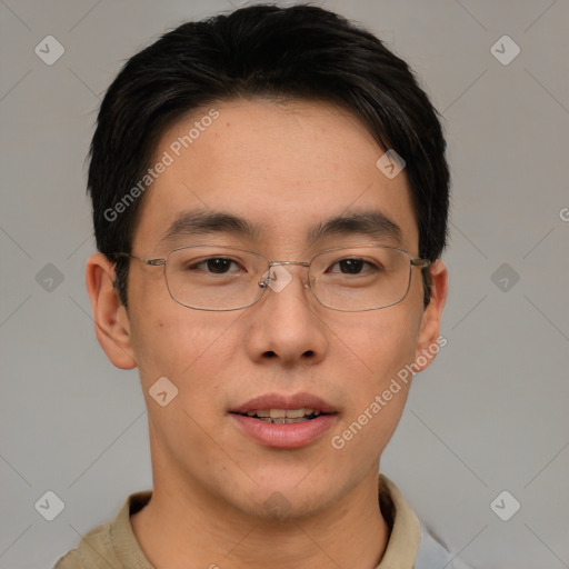 Joyful asian young-adult male with short  brown hair and brown eyes