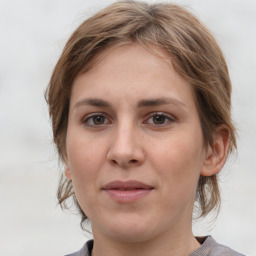 Joyful white young-adult female with medium  brown hair and grey eyes