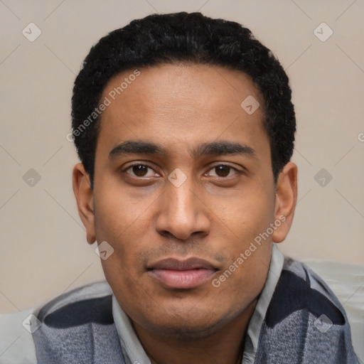Joyful latino young-adult male with short  black hair and brown eyes