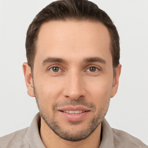 Joyful white young-adult male with short  brown hair and brown eyes