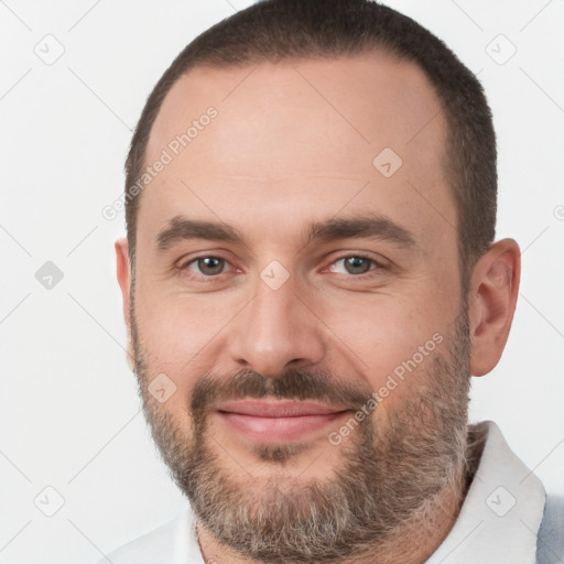 Joyful white adult male with short  brown hair and brown eyes