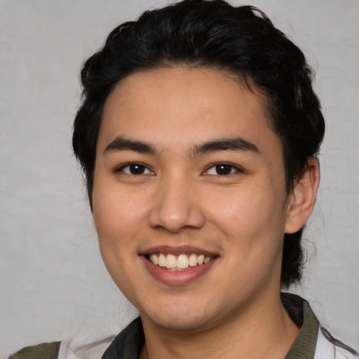 Joyful latino young-adult male with medium  black hair and brown eyes