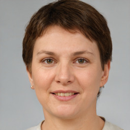 Joyful white adult female with short  brown hair and grey eyes