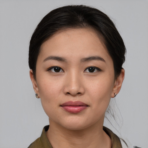 Joyful asian young-adult female with medium  brown hair and brown eyes