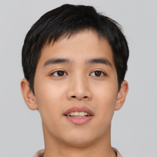Joyful asian young-adult male with short  black hair and brown eyes