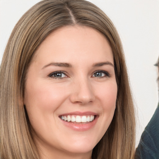 Joyful white young-adult female with long  brown hair and brown eyes