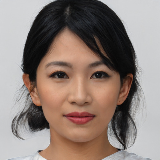 Joyful asian young-adult female with medium  black hair and brown eyes