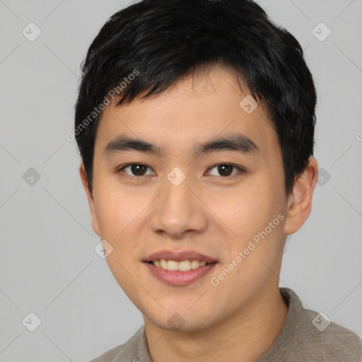 Joyful asian young-adult male with short  black hair and brown eyes