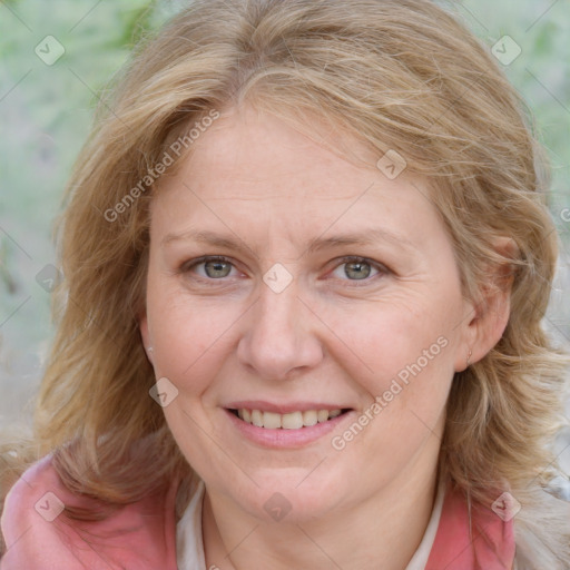 Joyful white adult female with medium  brown hair and blue eyes