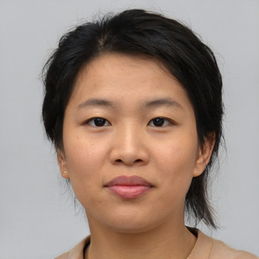 Joyful asian young-adult female with medium  brown hair and brown eyes