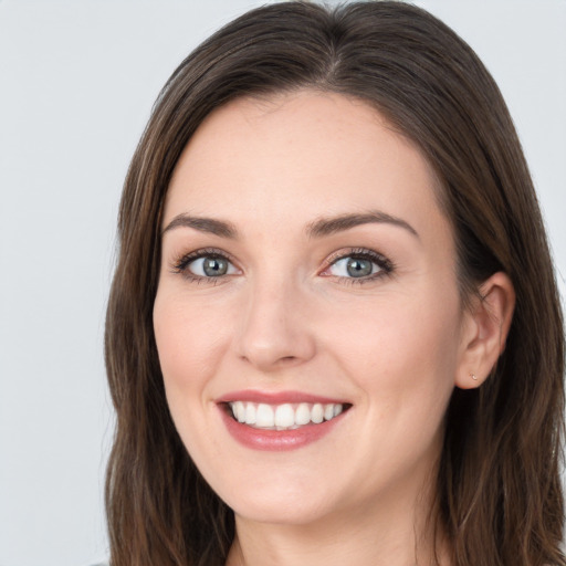 Joyful white young-adult female with long  brown hair and green eyes