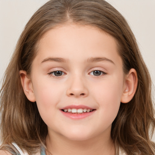 Joyful white child female with long  brown hair and brown eyes