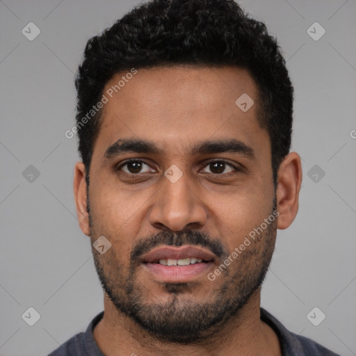 Joyful black young-adult male with short  black hair and brown eyes