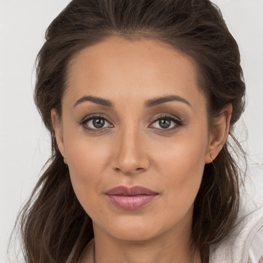 Joyful white young-adult female with long  brown hair and brown eyes