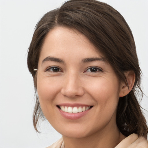 Joyful white young-adult female with medium  brown hair and brown eyes