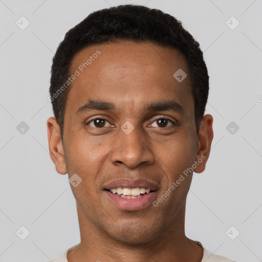 Joyful black young-adult male with short  black hair and brown eyes