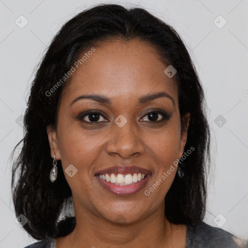 Joyful black young-adult female with long  brown hair and brown eyes