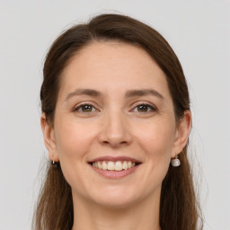 Joyful white young-adult female with long  brown hair and grey eyes