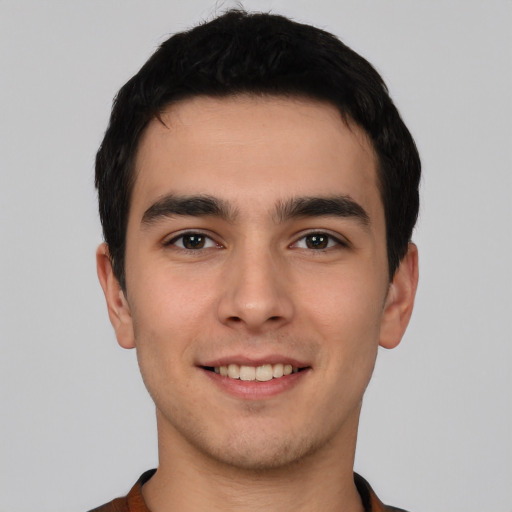 Joyful white young-adult male with short  black hair and brown eyes