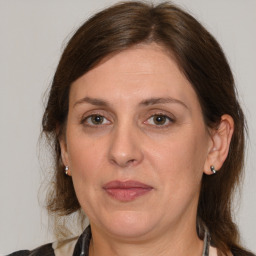 Joyful white adult female with medium  brown hair and grey eyes