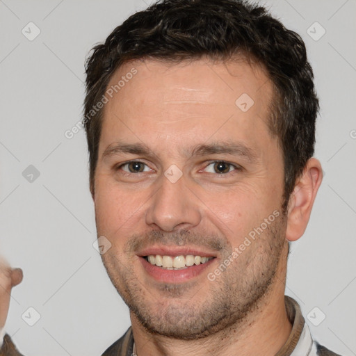 Joyful white young-adult male with short  brown hair and brown eyes