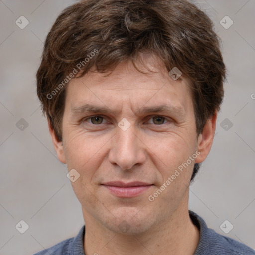 Joyful white adult male with short  brown hair and grey eyes