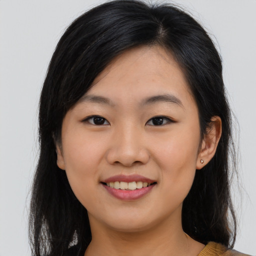 Joyful asian young-adult female with long  brown hair and brown eyes