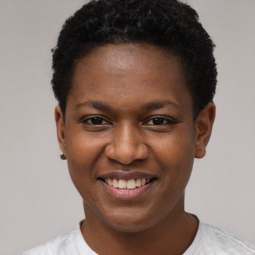 Joyful black young-adult female with short  brown hair and brown eyes